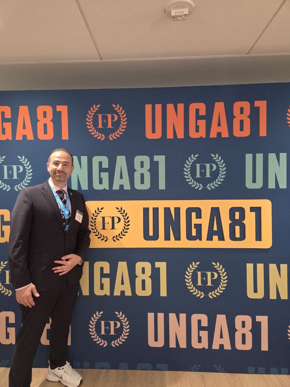 Abdulkader Rahmani in front of the UNGA 81 backdrop