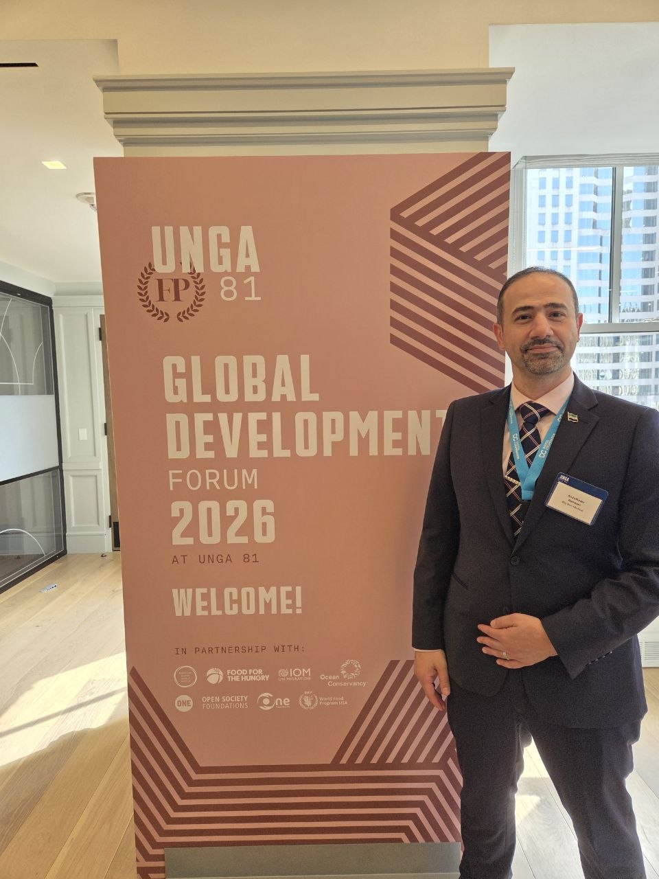 Abdulkader Rahmani beside the Global Development Forum 2026 sign